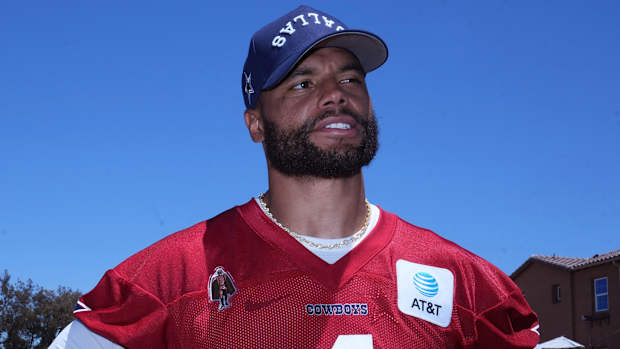 Cowboys quarterback Dak Prescott looks on.